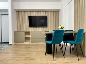 a meeting room with a table and blue chairs at Apartment No 604 Central Residence in Bucharest