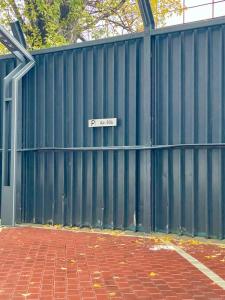 a blue fence with a sign that reads f gate at Apartment No 604 Central Residence in Bucharest