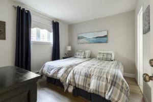 a bedroom with a bed with two pillows on it at InstantSuites- The Mountain Lake house in Mont-Tremblant