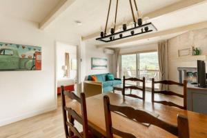 a dining room and living room with a dining table at InstantSuites- The Mountain Lake house in Mont-Tremblant