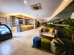 a lobby with a tv and a couch and a video game at 1 Bedroom Apartment in Aeon Towers I City Views I Free Wi-fi, Gym and Pool in Davao City