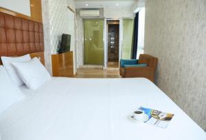 A bed or beds in a room at The Hera Platinum Hotel