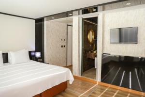 A television and/or entertainment centre at The Hera Platinum Hotel