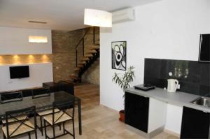 a kitchen and living room with a table and chairs at Vila Cube in Eforie Nord