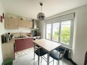 a kitchen with a table and chairs and a window at Appartement Douarnenez, Treboull hag ar mor in Douarnenez