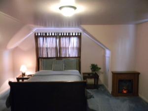 a bedroom with a large bed and a staircase at Welcome to the Wildwoods Hershey PA in Manor Acres