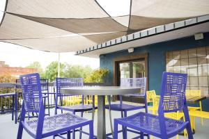 a group of blue chairs and a table andools at The Inn At Tree City, BW Signature Collection in McMinnville