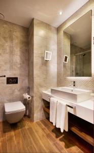a bathroom with a toilet a sink and a bathtub at Holiday Inn Istanbul - Kadikoy, an IHG Hotel in Istanbul