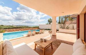a villa with a swimming pool and a patio at Casa Vistamar in S'Estanyol de Migjorn