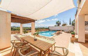 a patio with a table and chairs and a swimming pool at Casa Vistamar in S'Estanyol de Migjorn