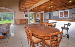 a dining room with a wooden table and chairs at 4 Bedroom Lovely Home In Azilone Ampaza in Azilone-Ampaza