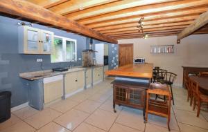 a large kitchen with a wooden ceiling and a table at 4 Bedroom Lovely Home In Azilone Ampaza in Azilone-Ampaza