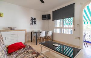 a living room with a couch and a table at Cozy Apartment In La Perla De Andalucía in Calahonda