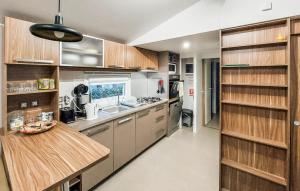 a kitchen with wooden cabinets and a wooden counter top at Beautiful Stacaravan in Saint-Brevin-les-Pins