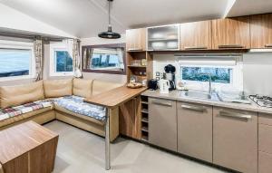 a kitchen with a couch and a table in a caravan at Beautiful Stacaravan in Saint-Brevin-les-Pins