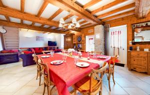 a large dining room with a red table and chairs at Nice Home In Fourches With Sauna in Fourches