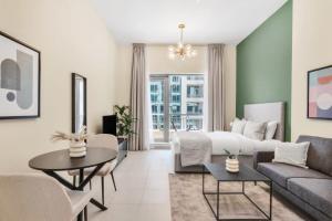 Silkhaus lovely studio with Downtown view in Boulevard central في دبي: غرفة معيشة بها سرير وأريكة
