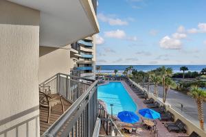 a balcony view of a resort with a swimming pool and the ocean at Seas the View at Ocean Reef Resort #320 in Myrtle Beach