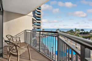 a balcony with a chair and a view of the ocean at Seas the View at Ocean Reef Resort #320 in Myrtle Beach