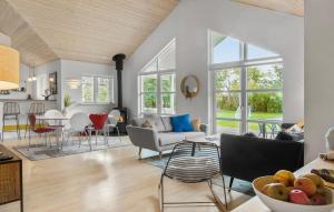 a living room with a couch and a table at Lovely Home In Dannemare With Sauna in Dannemare