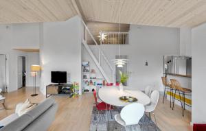 a living room with a white table and a couch at Lovely Home In Dannemare With Sauna in Dannemare