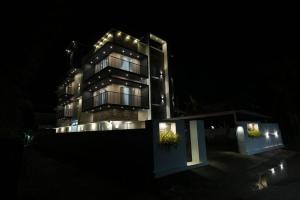 a building with lights on it at night at Rivera Residency Trivandrum in Murukkumpuzha