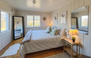 ein Schlafzimmer mit einem Bett und einem Tisch und zwei Fenstern in der Unterkunft Beautiful Home In Vestre Gausdal in Vestre Gausdal