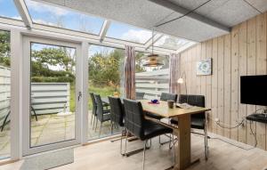 a dining room with a table and chairs at Stunning Apartment In Vejers Strand in Vejers Strand