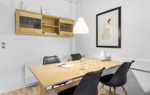 a dining room with a wooden table and chairs at 1 Bedroom Lovely Apartment In Nexø in Neksø