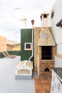 a patio with a pizza oven on a roof at OkStay Beach House Las Maretas Tenerife in Arico