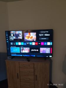 a flat screen tv sitting on top of a wooden stand at Haus Nuhn in Bad Wildungen