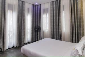 Ένα ή περισσότερα κρεβάτια σε δωμάτιο στο Residence Kahasha Nicolas RKN