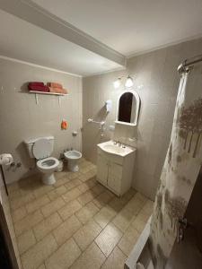 a bathroom with a toilet and a sink at Hermosa casa PH equipada y con patio. Aestrenar in Mar del Plata