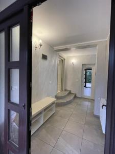 an open door to a hallway with stairs in a house at Holidays Home 4 You in Rădăuţi +20 photos