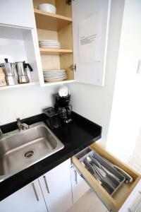 a kitchen with a sink and a counter top at Family Friendly Condo Steps to Miami Beach with Free Parking in Miami Beach +24 photos