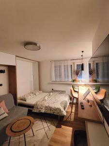 a bedroom with a bed and a table and chairs at Teka’s home in Sarajevo