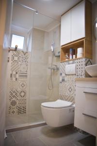 a bathroom with a white toilet and a shower at Teka’s home in Sarajevo +10 photos
