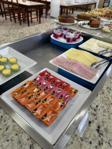 a buffet with different types of food on a table at Hotel Muller in Mariana