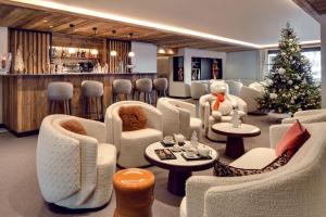 a waiting room with a christmas tree and a teddy bear at Antarès SIRIUS 503 - Spacious ski inski out apartment in Méribel +3 photos