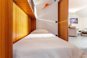 a bedroom with a bed with a wooden headboard at Sea View Terrace Sunset-Private Parking in Anacapri