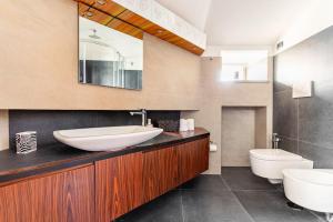 a bathroom with a sink and a toilet and a mirror at Sea View Terrace Sunset-Private Parking in Anacapri +53 photos