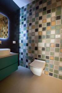 a bathroom with a toilet and a sink at Vila Luarasi Blue Apartment in Kaninë +15 photos