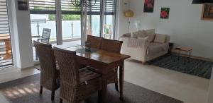 a living room with a table and chairs and a couch at Ferienwohnung Kolpingstraße in Neuburg an der Donau