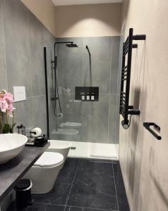 a bathroom with a shower and a toilet and a sink at Bonheur Luxury Rooms in Ercolano +29 photos