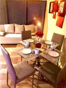 a table with plates and chairs in a living room at al VECCHIO ARCO Borgo Antico in Bari