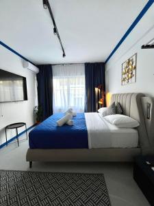 a bedroom with a bed with a teddy bear on it at Voulis 45 Plaka Suite by Zeussuites in Athens
