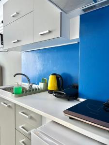 a kitchen with a sink and a laptop on a counter at Voulis 45 Plaka Suite by Zeussuites in Athens +15 photos