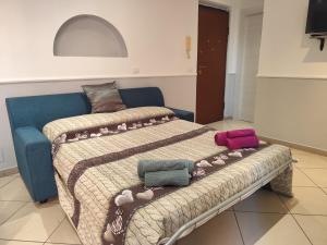 a bedroom with a bed with blankets and pillows on it at Casa Ludovica Centocelle in Rome