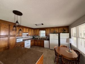 a kitchen with white appliances and a table with chairs at Paradise Point 2BR 2BA in Lake Murray Shores