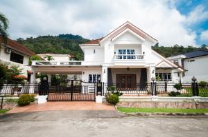 a white house with a black fence at Bukit Mertajam Double Storey Bungalow 15pax BBQ KTV in Bukit Mertajam